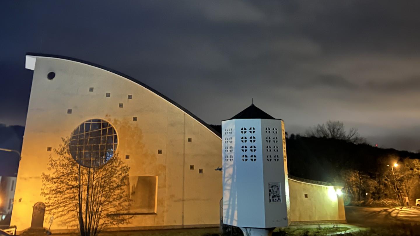 Eine hell beleuchtetet Kirche in der Nacht